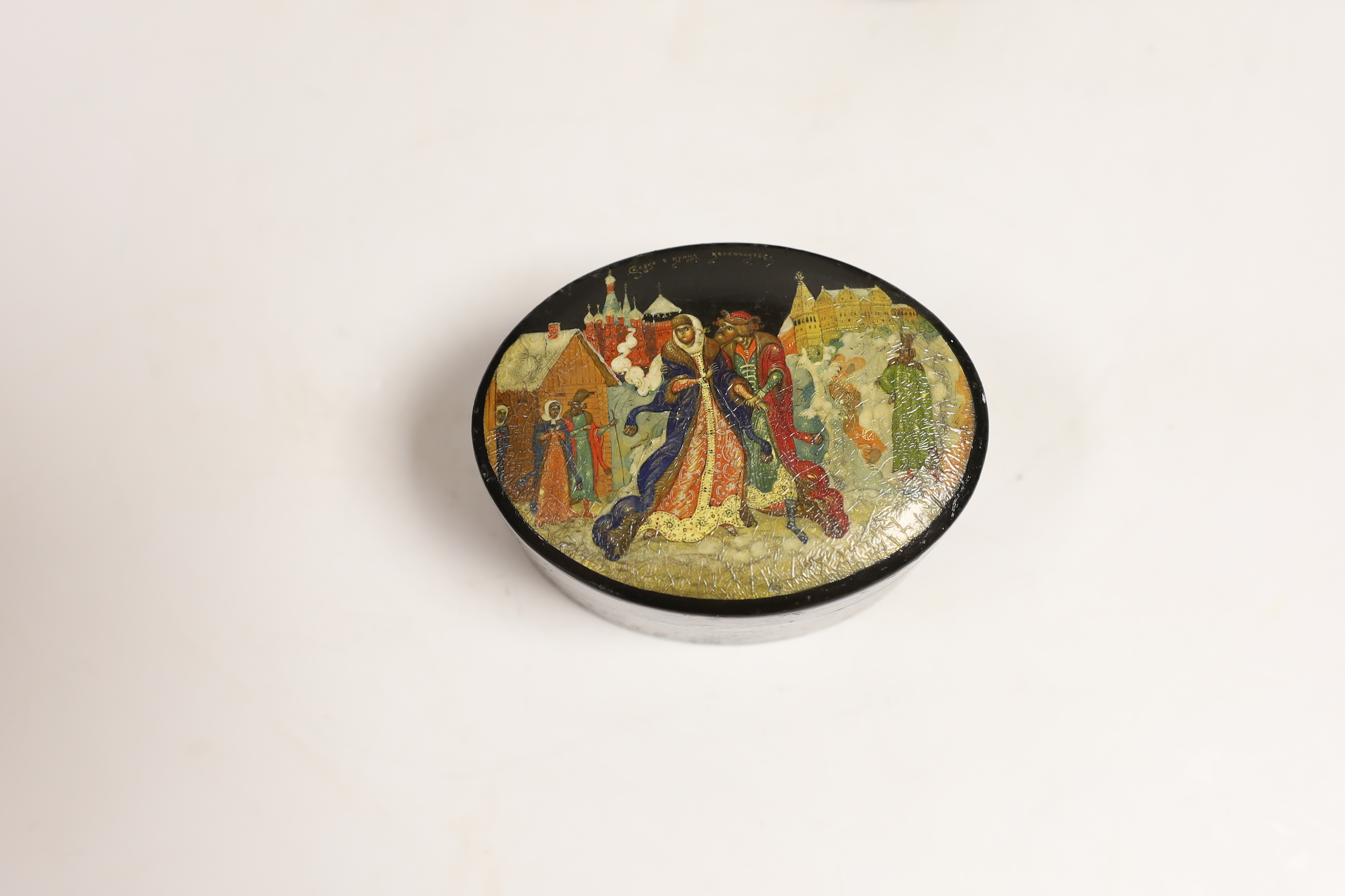 Four Russian lacquer boxes and a similar napkin ring, Palekh and others, the oval box painted with figures from legend and the others with rural scenes, some inscribed with the subject or artist, largest 13.7cm wide (5)